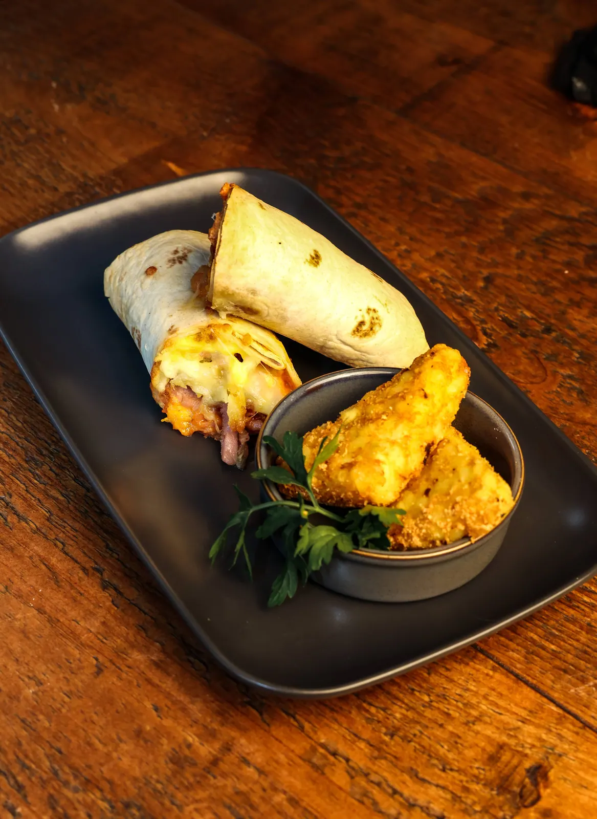 A loaded wrap and fried chicken served with slaw and dipping sauces.